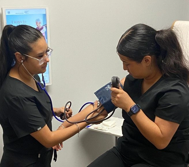 students practicing taking blood pressure measurements